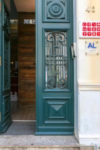 eine grüne Tür mit einem Metalltor an einem Gebäude in der Unterkunft Guest House Porto Clerigus in Porto