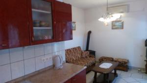 a kitchen and living room with a couch and a table at Lubin in Sevid +9 photos
