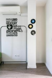 a room with a white wall with records on the wall at Guest House Porto Clerigus in Porto