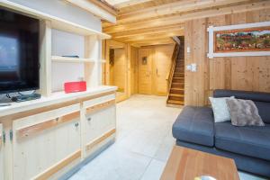a living room with a couch and a flat screen tv at Simply Morzine - Apartment du Centre in Les Gets