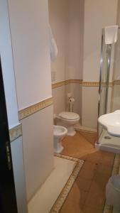 a bathroom with a toilet and a sink at Hotel Santa Marina Antica Foresteria in Santa Marina Salina