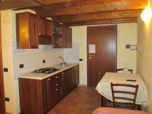 a kitchen with a sink and a stove and a table at Agriturismo Il Vecchio Carro in Campli