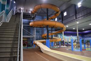 a playground with a slide in a building at Metropolis Resort - Eau Claire in Eau Claire