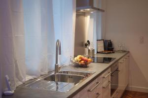 a kitchen with a sink and a bowl of fruit at The Appart in Lille