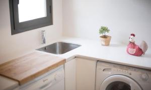 a kitchen with a sink and a washing machine at Apartamento Centro Tarragona in Tarragona