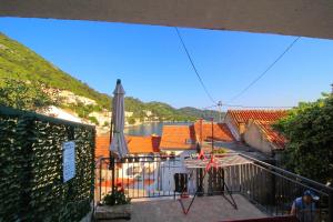 a balcony with an umbrella and a body of water at Apartment Mambo in Sobra