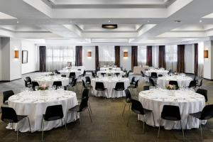 a banquet hall with white tables and chairs at Rafaelhoteles Atocha in Madrid