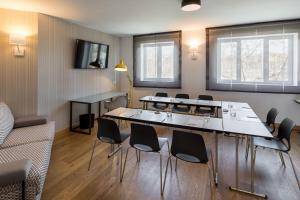 a meeting room with a large table and chairs at Rafaelhoteles Atocha in Madrid