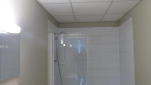 a bathroom with a shower with a glass door at Abc Hotel in Toul