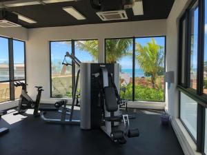 a gym with a view of the ocean at Azuri Appartement De Luxe & Pool in Roches Noires