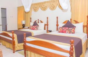 Een bed of bedden in een kamer bij Hotel Alexandrina