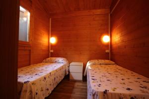Ένα ή περισσότερα κρεβάτια σε δωμάτιο στο CAMPING CALATELLA parco di vacanza