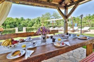 a wooden table with food on top of it at Villa Dora in Umag