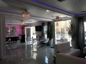 a living room with chairs and tables and pink walls at Hollywood VIP Hotel in Los Angeles