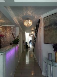 a hallway with purple lighting and a hallway with stairs at Hollywood VIP Hotel in Los Angeles