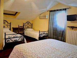 a bedroom with two beds and a window at Casa De Campo in Montegranaro +21 photos