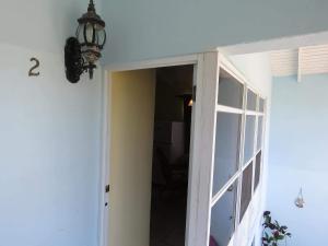 a chandelier hanging over a door in a room at Ellen Bay Cottages in Saint Philips