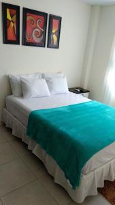 a bedroom with a large bed with a blue blanket at Casa Estrella Santa Rosa in Santa Rosa