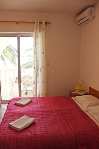 a bedroom with a bed with two towels on it at Apartments Pansion Franka in Brist