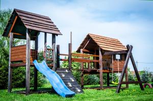 a playground with a slide and a play house at Domki nad Szelągiem in Kątno