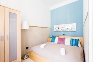 a bedroom with a bed with two white towels on it at Legerova 33 Apartments in Prague