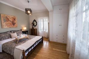 a bedroom with a bed and a table in it at La casa di Iro in Lefkada