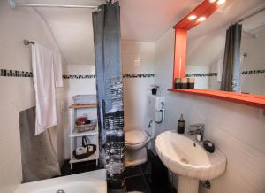 a bathroom with a sink and a toilet and a shower at La casa di Iro in Lefkada