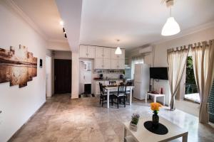 a kitchen and living room with a table and chairs at La casa di Iro in Lefkada +23 photos