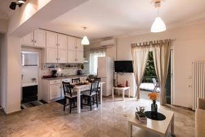 a kitchen and living room with a table and chairs at La casa di Iro in Lefkada