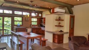 a living room with a table and a kitchen at Wicks Getaway - 2bdrm Townhome in San Juan del Sur