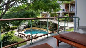 a balcony with a view of a swimming pool at Wicks Getaway - 2bdrm Townhome in San Juan del Sur