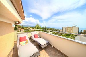 a balcony with two chairs and a view of the ocean at Apartments VALL in Krk