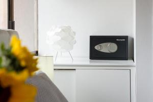 a small radio sitting on a white counter next to a chair at Penthouse Lodge B&B in Quito