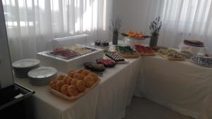 a table with different types of bread and pastries on it at Malucri Resort in San Giovanni Rotondo