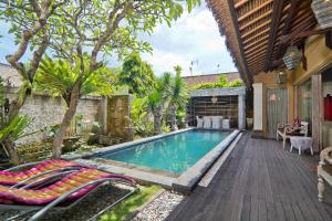a swimming pool in the backyard of a house at Bamboo Moon Villas in Sanur