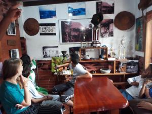 a group of people sitting in a room at Casa Cultural Mindo in Mindo