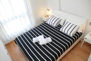 A bed or beds in a room at Teatro Cervantes SigloXXI