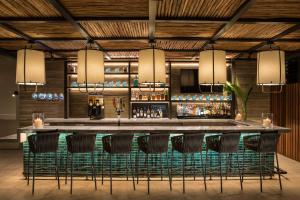 a bar in a restaurant with chairs around it at 'Alohilani Resort Waikiki Beach in Honolulu