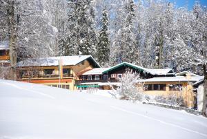 a resort in the snow with snow covered trees at Gästehaus Schröder in Ruhpolding