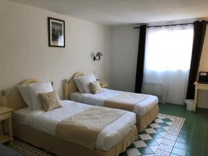 Postel nebo postele na pokoji v ubytování Hotel Le Cilaos