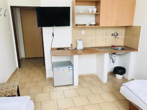 a small kitchen with a desk and a sink at Dusan Apartments in Orlová