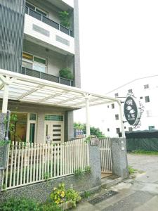 a building with a white fence in front of it at 懶羊羊民宿Cozy Sheep in Chishang
