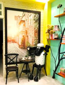 a room with a table and a stuffed animal sitting in a chair at 懶羊羊民宿Cozy Sheep in Chishang