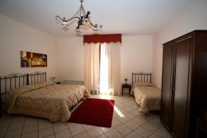 מיטה או מיטות בחדר ב-Affittacamere La Piazzetta