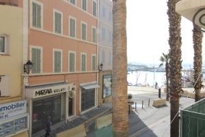 a view from a balcony of a building and a street at Appartement T2 sur le port de sanary in Sanary-sur-Mer