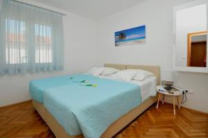 Postel nebo postele na pokoji v ubytování Apartmani Trogir
