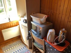 a kitchen with a stove and a blender on a table at Björnvålsfallet in Deje