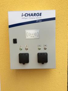 an electrical outlet with a charger on a wall at Villa Desiree - Hotel Garni - Adults Only in Egg am Faaker See