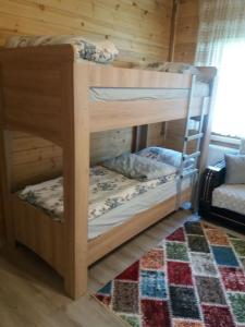 two bunk beds in a room with a rug at Katipogulları Apart in Uzungol +17 photos