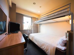 a bedroom with a bed and a desk with a computer at Super Hotel Inn Kurashiki Mizushima in Kurashiki +89 photos